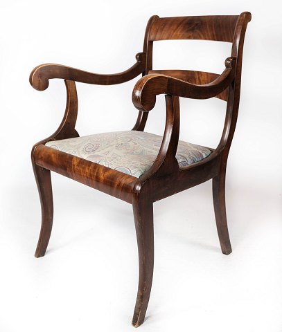 Empire antique armchair of mahogany and upholstered with light fabric from the 
1840s.

