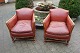 A pair of easy chairs from around the year 1930, in patinated red leather. 5000m2 showroom.