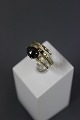 14 carat gold ring with brilliants and a black gem, size 55.5000 m2 showroom.