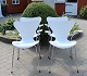 4 White seven chairs, model 3107,  with armrests, designed by Arne Jacobsen and manufactured by Fritz Hansen.5000m2 showroom.