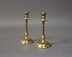 A pair of small candlesticks in brass.5000m2 showroom.
