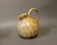 Ceramic jug in light brown colors by an unknown artist, numbered 219.5000m2 showroom.
