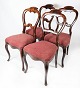 Set of four dining room chair of mahogany and upholstered with red fabric from 
the 1860s.
